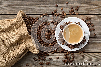 Opened coffee bag with beans and white cup of coffe Stock Photo