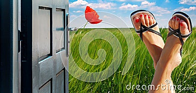 Opened door concept with crossed feet and a greeny country in the background Stock Photo