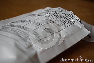Opened envelope sent from China with a table with a form on its cover Stock Photo
