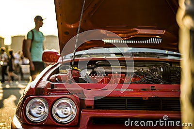 Opened fast race muscle car bonet during a sunset Stock Photo