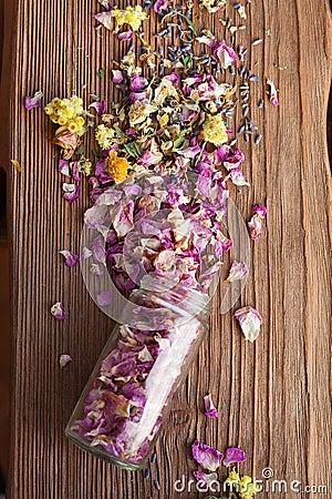 Opened glass bottle with dry mix of flowers Stock Photo