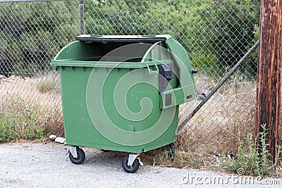 Opened green garbage container Stock Photo