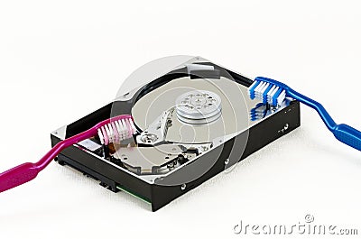 Opened hard-disc with two toothbrushes Stock Photo