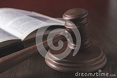 opened juridical book with hammer on wooden table, Stock Photo