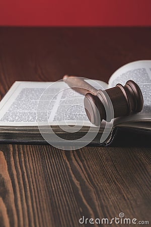 opened juridical book with hammer on wooden table, Stock Photo