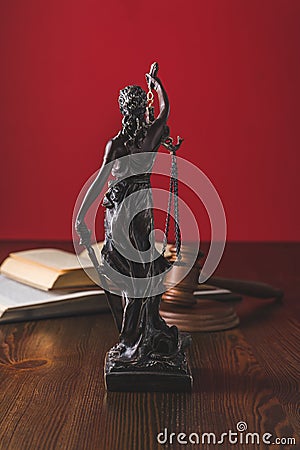 opened juridical books with lady justice statue on wooden table, Stock Photo