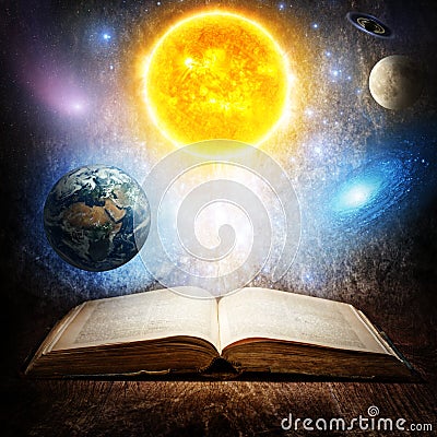 Opened magic book with sun, earth, moon, saturn, stars and galaxy. Concept on the topic of astronomy or fantasy. Elements of this Stock Photo