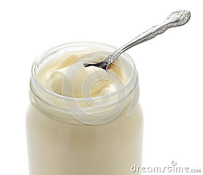 Opened mayonnaise jar and spoon Stock Photo