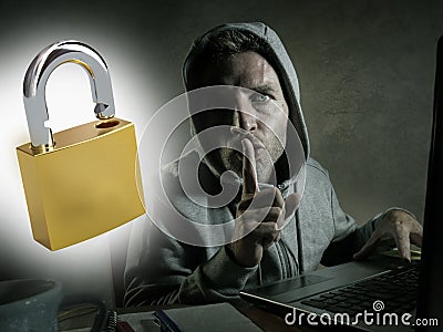 Opened padlock composite with young dangerous and skilled hacker manprogramming on laptop computer system cracking password in Stock Photo