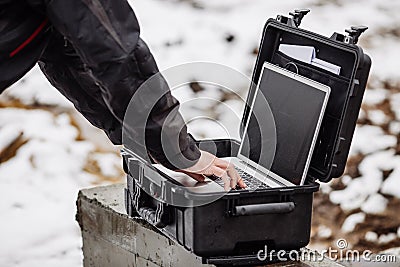 Opened plastic protector case with laptop lying on a constructi Stock Photo