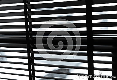 Opened venetian plastic blinds in black and white. Plastic window with blinds. Interior design of living room with window Stock Photo