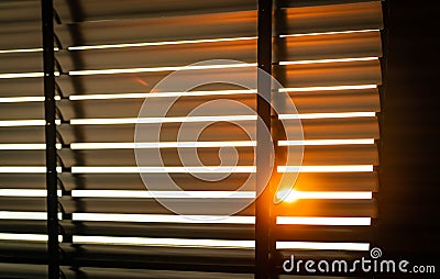 Opened venetian plastic blinds with sunlight in the morning. White plastic window with blinds. Interior design of living room Stock Photo