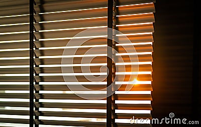 Opened venetian plastic blinds with sunlight in the morning. White plastic window with blinds. Interior design of living room Stock Photo