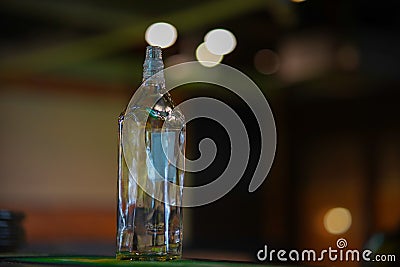 Opened whisky bottle on a wooden table with a dark background. Stock Photo