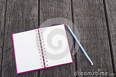 Opened white page of blank realistic spiral notepad notebook and blue pencil on wood texture background Stock Photo