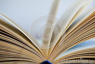 Opened yellow book pages close up shot on white Stock Photo