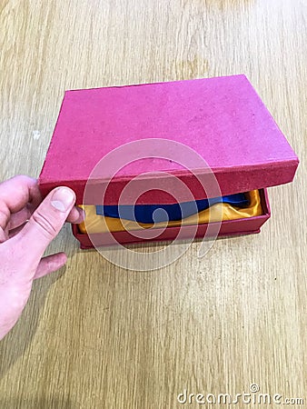 Opening a brightly colored gift box. Stock Photo