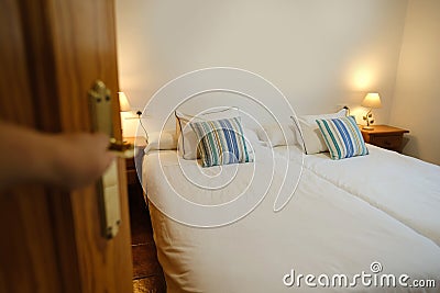 opening door to bright room open, Cozy Beds in Hotel, Serene Sleep Haven, Soft Hotel Pillows and Bedding, Rejuvenating Hotel Stay Stock Photo