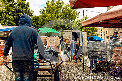 Opening of food markets in Europe during quarantine and the coronavirus pandemic. People violate social distance and do not wear Editorial Stock Photo