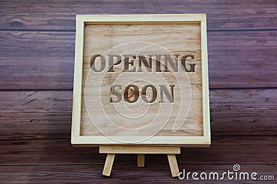 Opening soon text engraved on wooden frame. Business opening concept Stock Photo