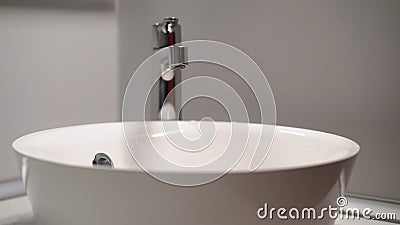 Opens the mixer valve. A jet of water runs from a water pipe. Stock Photo