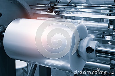 The operation of automatic plastic bag production machine with lighting effect. Close-up of the roller of the plastic bag producti Stock Photo