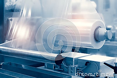 The operation of automatic plastic bag production machine with lighting effect. Close-up of the roller of the plastic bag producti Stock Photo