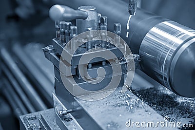 The operation of lathe machine cutting the steel shaft. Stock Photo