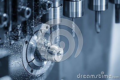The operation of multi-tasking CNC lathe machine swiss type making the pipe connector parts. Stock Photo