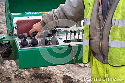 Operator hand on controls of core drilling machine Stock Photo