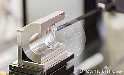 Operator inspection automotive part by contour measuring machine Stock Photo