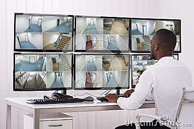 Operator Looking At Multiple Camera Footage Stock Photo