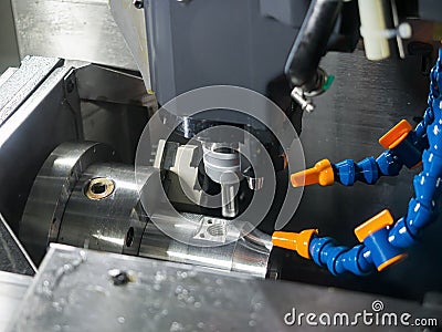 Operator machining precision part by CNC machining center 5 axis Stock Photo