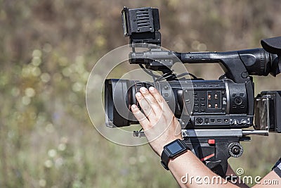 The operator photographer takes on a professional camera interviews Stock Photo