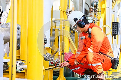 Operator recording operation of oil and gas process at oil and rig plant, offshore oil and gas industry, offshore oil and rig Stock Photo