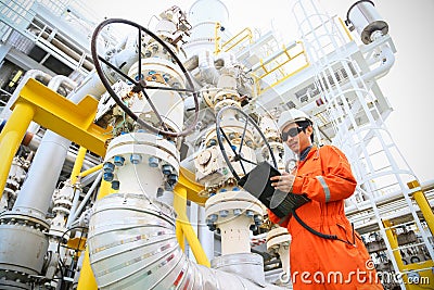 Operator recording operation of oil and gas process at oil and rig plant, offshore oil and gas industry, offshore oil and rig Stock Photo