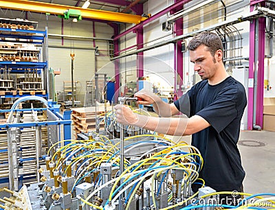 Operator repairs a machine in an industrial plant with tools - p Stock Photo