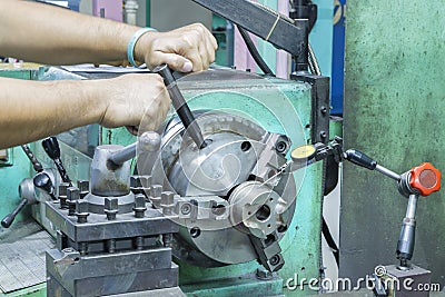 Operator setup turning part on manual lathe machine Stock Photo