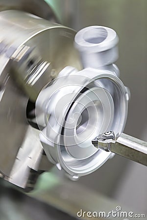 Operator turning automotive parts by cnc lathe Stock Photo