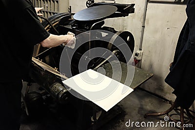 Operator at work on old typographic machine Stock Photo