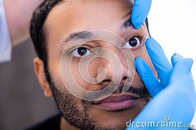 Ophtalmologist dropping eye drops to patients eyes Stock Photo