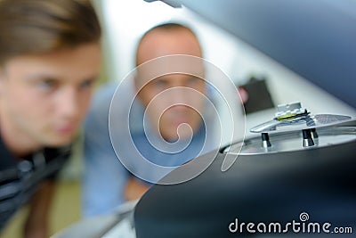 Ophtalmologist with intern looking at lense Stock Photo