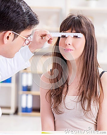 Ophthalmologist is checking up patient in eye doctor hospital Stock Photo