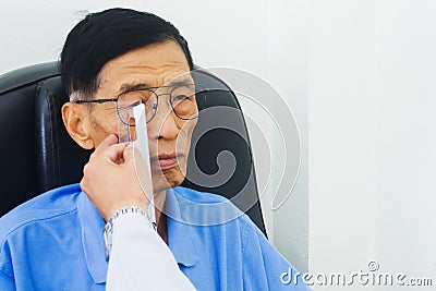 The ophthalmologist determines the distance centers of the lenses with ruler tool. Stock Photo