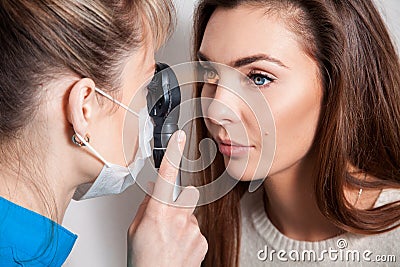 Ophthalmologist examines the eyes using a ophthalmic device Stock Photo