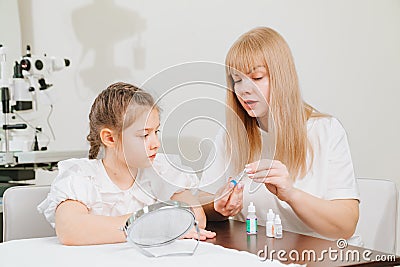 ophthalmologist explains to girl how to use night treatment contact lenses Stock Photo