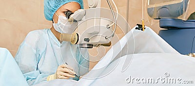 Ophthalmology laser microscope operation. Doctor in clinic. Patient eye treatment. Myopia and cataract removal Stock Photo