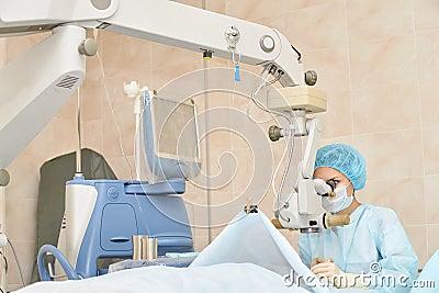 Ophthalmology laser microscope operation. Doctor in clinic. Patient eye treatment. Myopia and cataract removal Stock Photo