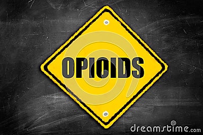 Opioids written on caution sign Stock Photo