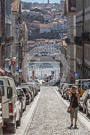 View of a street on Porto downtown, with traditional buildings, people, vehicles Editorial Stock Photo